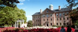 South Building, center, is the main administrative building at the University of North Carolina at Chapel Hill. At left is the Old Well, the visual symbol of the university.