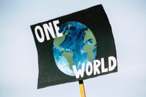 student holding up sign about changing the world