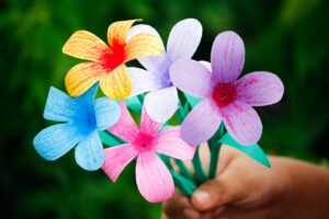 hand holding bouquet of flowers in different diverse colors