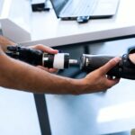 biomedical engineer examining prosthetic arm