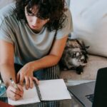 student writing draft of college application essay